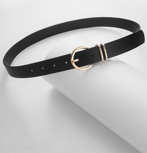 Close-up of elegant black leather belt with polished gold round buckle and double metal loops