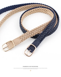 Detailed view of woven textures and polished gold square buckles on two women belts