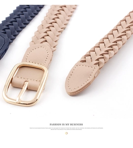 Close-up of woven belts with gold square buckles and detailed stitching in navy and beige