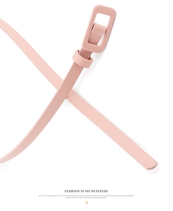 Detail view of pink patent leather skinny belt with color-matched rectangle buckle