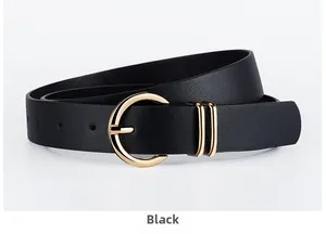 Detail of black textured PU leather belt for women with elegant golden round buckle