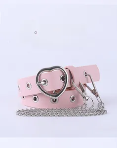 Detail of pink leather belt with silver heart buckle and detachable metal chain charm