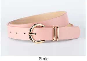 Detail of pink PU leather belt with a round golden metal buckle and dual fixed loops