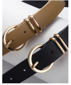 Detail of minimalist women's PU leather belts in black and khaki with gold round buckles