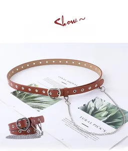 Detail view of camel heart-buckle belt with metal eyelets and decorative silver chain