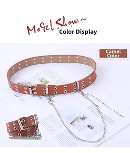 Dettaglio cintura color cammello con occhielli a stella, fibbia argento e catena decorativa