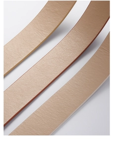 Detailed macro view of litchi textured PU leather belts in beige and pink tones