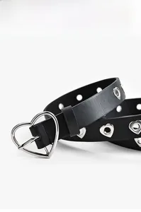 Détail d'une ceinture en cuir noir avec boucle en forme de cœur et œillets creux