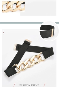 Detail view of elastic waist belt featuring interlocking chunky gold chain buckle