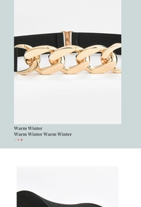 Close-up of a women's black elastic waist belt with a large polished gold chain buckle