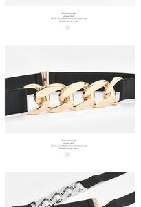 Detail of black elastic belt featuring bold gold and silver chain link buckle closure