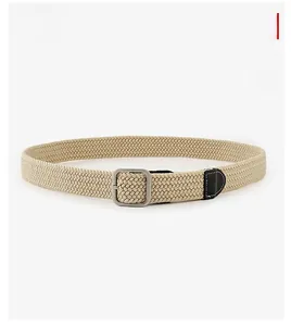 Detail of beige woven elastic belt with silver square buckle and black leather tip