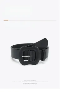 Close-up of black women's belt showing leather texture and unique wavy buckle detail