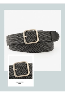 Detail of grey braided elastic belt featuring matte silver square buckle and leather tip