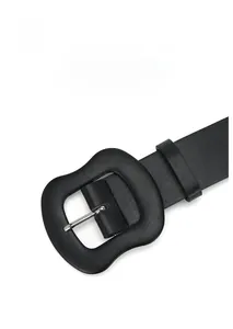 Detail of matte black zinc alloy buckle on polished leather belt for jeans