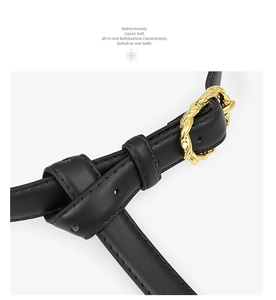 Détail de la ceinture en cuir noir avec boucle dorée torsadée au design vintage femme