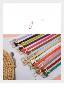 Detail shot of slim leather belts with gold double-ring buckles in multiple vibrant colors