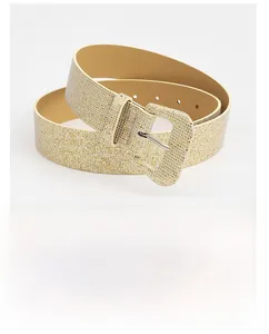 Close-up of women's gold glitter wide waist belt with matching square wrapped buckle