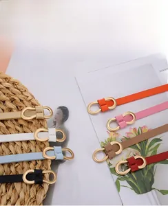 Collection of thin women belts with gold infinity buckles in 8 vibrant colors