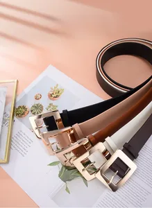 Flat lay of multiple color minimalist PU leather belts with gold square buckles for women