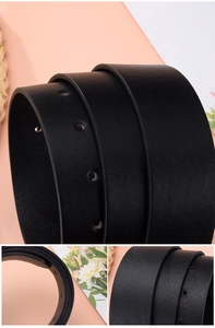 Close-up of black leather belt showing litchi texture and neat edge sealing detail