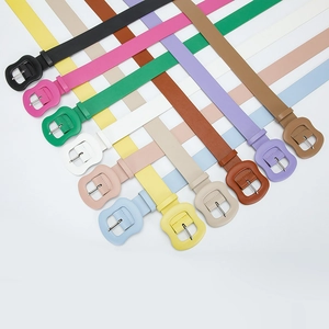 Colorful minimalist faux leather belts with matching buckle displayed in various vibrant hues