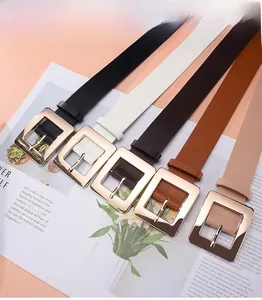 Flat lay of multiple minimalist leather belts for women with square gold buckles in five colors