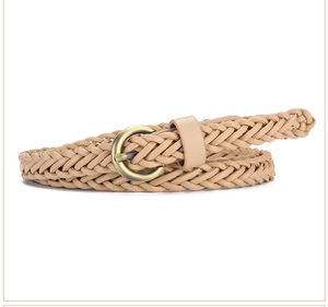 Detail of light khaki woven belt with retro gold round buckle on white background