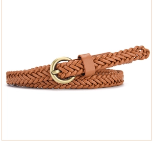 Detailed view of brown woven belt with an antique gold round buckle on white background