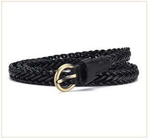 Close-up of black braided leather belt with vintage gold round buckle on white background