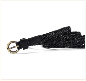 Close-up of black braided thin belt featuring a vintage bronze round metal buckle