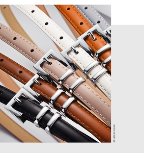 Close-up of thin leather belts with silver rectangular buckles in multiple classic colors