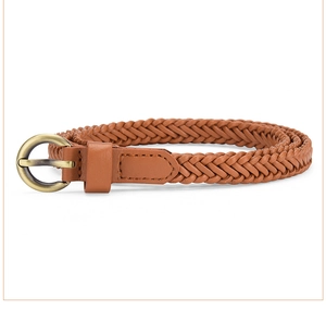 Close-up of brown woven belt with antique bronze round buckle and fine braided texture
