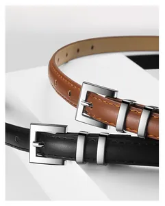 Detail of slim leather belts with silver alloy pin buckles in brown and black
