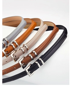 Detailed view of women's thin leather belts in five colors with silver needle buckles