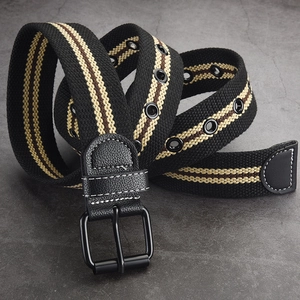 Men's striped canvas belt with double prong buckle and eyelets on rock background