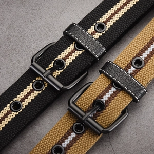 Striped canvas belt with matte metal buckle and reinforced eyelets on a stone background