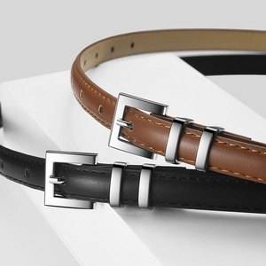 Minimalist slim leather belts with silver buckle in black and brown on a white stand
