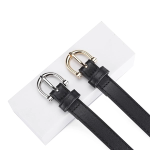 Slim PU leather belts for women with gold and silver horseshoe buckles on white cubes