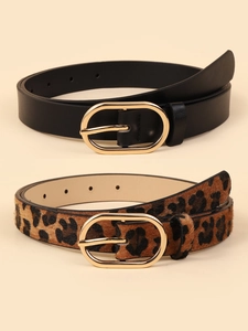 Detail view of leopard print faux horsehair and black leather belts with gold buckles