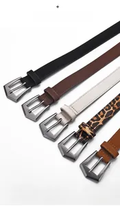 Detailed macro view of soft cowhide leather belts with vintage brushed alloy buckle sets