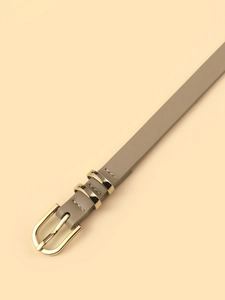 Detailed close-up of taupe PU leather belt with gold metal buckle and neat stitching