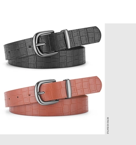 Close-up of black and brown crocodile pattern faux leather belts with vintage pin buckles