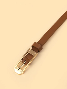 Detail of slim brown leather belt featuring a polished gold rectangular alloy buckle