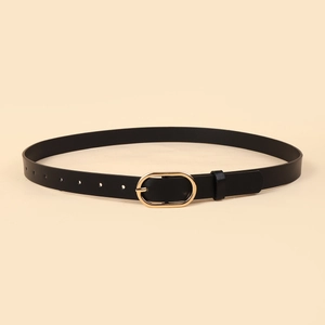 Close-up of black skinny leather belt with polished gold oval buckle and precise holes