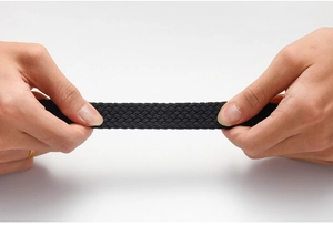 Close-up of flexible black woven elastic belt showing strong stretch and recovery texture
