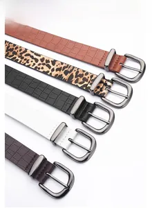 Detail of zinc alloy pin buckles with crocodile and leopard texture faux leather belts