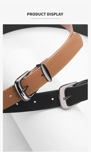Detail showing slim brown and black faux suede belts with metallic pin buckles