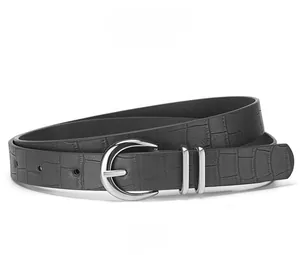 Detail of black faux leather skinny belt featuring crocodile pattern and silver buckle