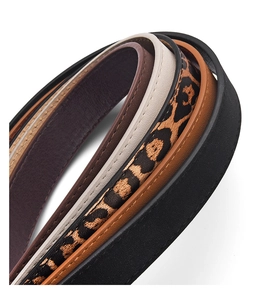 Close-up of leopard print and matte PU leather belts with fine stitching details